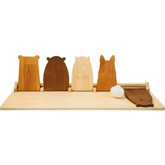 three wooden bears sitting on top of a table