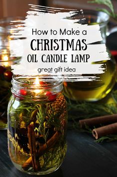 a glass jar filled with christmas oil and spices on top of a table next to cinnamons