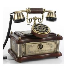 an old fashioned phone sitting on top of a wooden box