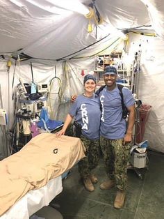 two people standing next to each other in a room filled with medical supplies and equipment