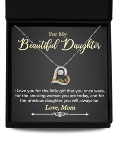 a necklace with the words for my beautiful daughter in gold and silver, on a black box