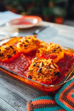 a glass dish filled with food on top of a wooden table