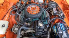 the engine compartment of an orange car is shown