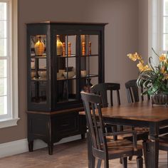 a dining room table with chairs and a china cabinet