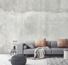 a grey couch sitting on top of a white floor