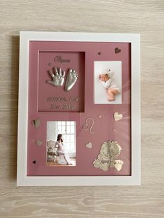 a baby's hand and foot casts are displayed in a pink frame with hearts