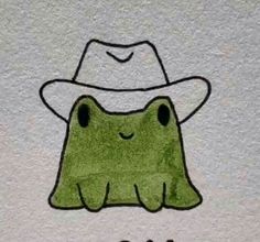 a drawing of a green frog wearing a white hat with eyes drawn on it's face