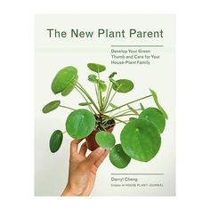 the new plant parent book cover with a hand holding a potted plant in front of it