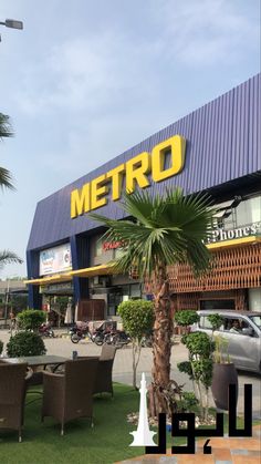 a building that has a palm tree in front of it and some cars parked outside