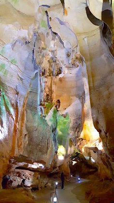 a man is walking through a cave like area