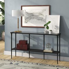 a living room scene with focus on the console table and artwork above it, along with a rug