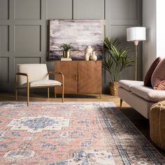 a living room filled with furniture and a rug