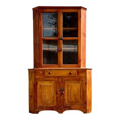 an old wooden cabinet with glass doors on the top and bottom, against a white background