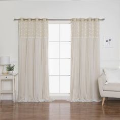 a white couch sitting next to a window in a living room