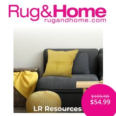 a gray couch with yellow pillows and a pink sign that says rugs & home