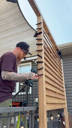 a man is working on a wooden structure