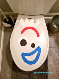 a toilet with a funny face painted on it