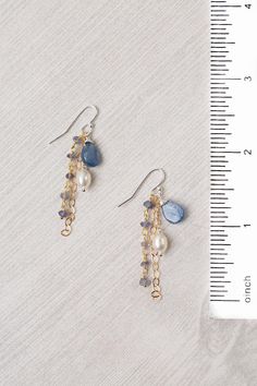 Experience the beauty and craftsmanship of the Seaside Collection with these gorgeous handmade earrings. Mixed Metal (lead and nickel free) Kyanite, Iolite, Pearl 2", with sterling silver ear wires We hand select our natural materials, thus there may be slight variations in color and/or size that will not detract from the overall aesthetic Our unique handcrafted designer jewelry for women is made in America, with each design created individually in our personal design studio in Floyd VA USA Earring Handmade Ideas, Jewelry Inspo Earrings, Boujee Jewelry, Bridgerton Diy, Diy Beaded Jewelry, Floyd Va, Kyanite Jewelry, Pretty Jewelry Necklaces, Jasper Jewelry