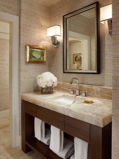 a bathroom with two sinks and a large mirror above it's counter top area