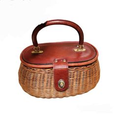 a brown wicker purse with handle on white background