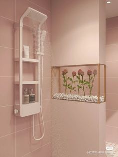 a shower head with flowers in it and shelves on the wall next to it,