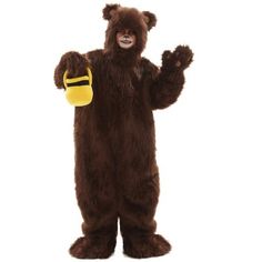 a man in a brown bear costume is standing with his hands out and wearing a yellow glove