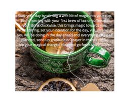 a green mug filled with tea next to a slice of orange and a tag that says start by stringing a web of magic into your cup