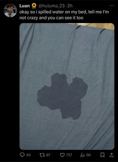 a blanket that is laying on top of a bed with the shadow of a flower