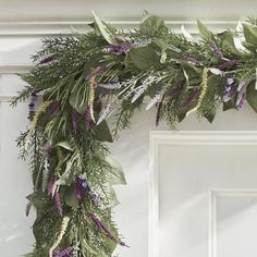 a green and purple wreath hanging from the side of a door