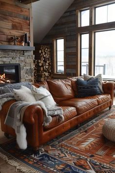 a living room filled with furniture and a fire place in front of a window on top of a rug