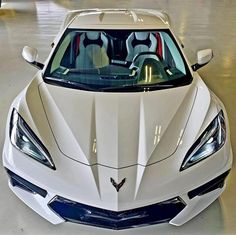 the front end of a white sports car