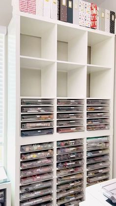 a white book shelf filled with lots of cds