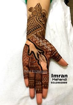 a woman's hand decorated with henna on her left and right hand is shown