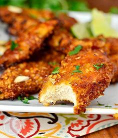 some fried food on a white plate with green garnish