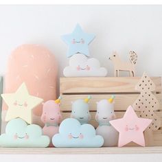 there are many stars and clouds on the shelf next to each other, all in pastel colors