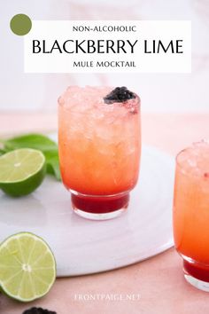 two glasses filled with blackberry lime mule cocktail on a white plate next to blackberries and limes