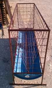 a metal cage with a blue surfboard in it