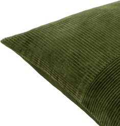 a green corded pillow sitting on top of a white surface