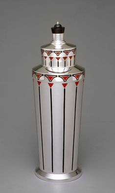 a white and black vase sitting on top of a table