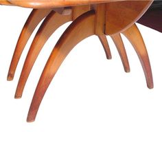 a wooden table with three curved legs