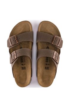 Effortless and legendary design with these Birkenstock Arizona Sandals for Men in Mocha. You’ll be wearing this shoe to every outdoor barbeque, beach party, and lake day. Don’t sacrifice your comfort for style, these sandals have got you covered in both areas!Features:BirkenstockStyle: 151181MColor: MochaNatural Leather insoleSuede footbed liningBirkibuc® synthetic leather upperEVA outsoleTwo straps with adjustable metal bucklesBirkenstock branded logo on inner shaftRegular widthEuropean sizingImportedWondering about the size conversion between women’s, men’s and youth Birkenstocks? Check out our Birkenstock Size Conversion ChartWant some more information about the must have casual shoe? Check Out our Blog! Mens Birkenstocks, Birkenstock Mocha, Outdoor Barbeque, Birkenstock Style, Birkenstock Men, Lake Day, Birkenstock Sandals Arizona, Sandals For Men, Youth Shoes