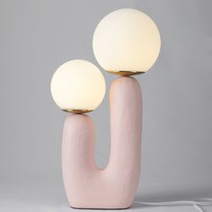 two pink lamps sitting on top of each other