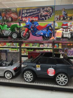 toy cars and motorcycles are on display in a store