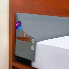 there is a cell phone in the pocket of this bed