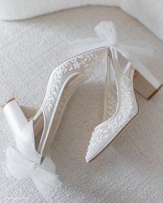 a pair of white high heeled wedding shoes