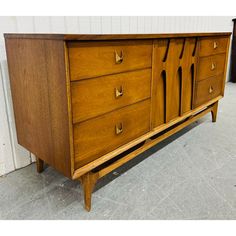 This listing is for a Mid-Century Modern Broyhill Brasilia Walnut 9-Drawer Dresser. Featuring a straight line design, three drawers on each side with original Brasilia brass hardware, sculpted center doors that open up to three hidden drawers, modern legs, and a beautiful walnut finish. This is an exceptional combination of quality and design by Broyhill! Straight Line Design, Broyhill Brasilia, Straight Line Designs, Mid Century Dresser, Jens Risom, George Nakashima, Hickory Chair, 9 Drawer Dresser, Hooker Furniture