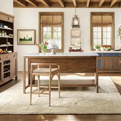 a large kitchen with wooden cabinets and an island in front of the stove top oven