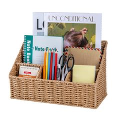 a wicker basket filled with books and office supplies on a white background for display