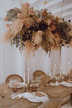 the table is set with flowers, candles and place settings for dinner guests to enjoy