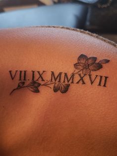 a close up of a tattoo on the back of a woman's shoulder that says vil xx mmxvi